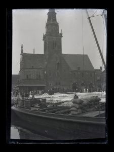 Circa 1930: Cheese market seen from Voordam with Waag building and moored ship of Freight Forwarding P. Verwer
