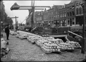 Circa 1925: Cheese market with Voordam and Schapenbrug.